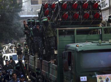 Masked Hamas members parade with Qassam rockets through the streets of Khan Younis, southern Gaza Strip, on May 27, 2021. (AP/Yousef Masoud)