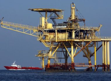 A supply boat, lower left, passes an oil production platform in the Gulf of Mexico. File Photo by A.J. Sisco/UPI