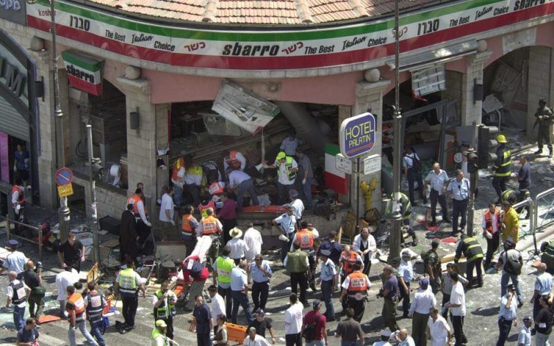 Police and medics surround the scene of a bomb explosion in a restaurant downtown Jerusalem, Aug. 9, 2001. (AP Photo/Peter Dejong)