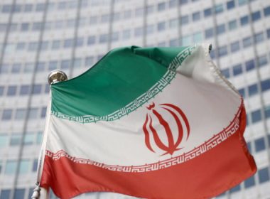 The Iranian flag waves in front of the International Atomic Energy Agency headquarters in Vienna on March 1, 2021. (Lisi Niesner/Reuters)