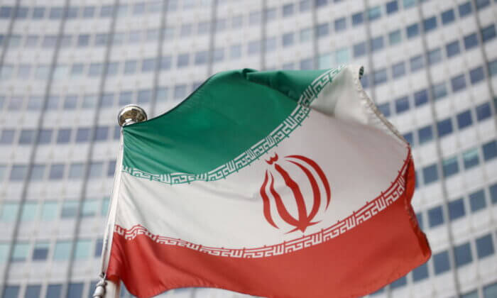 The Iranian flag waves in front of the International Atomic Energy Agency headquarters in Vienna on March 1, 2021. (Lisi Niesner/Reuters)