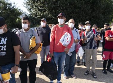 Migrants hold Red Cross blankets after arriving at Union Station near the U.S. Capitol from Texas on buses on April 27, 2022, in Washington. AP