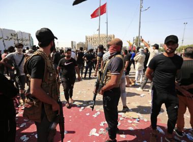 Fighters from the Saraya Salam (Peace Brigades) loyal to influential Shiite Iraqi cleric Muqtada al-Sadr deploy in Baghdad, Iraq, August 30, 2022. (AP Photo/Murtadha Ridha)
