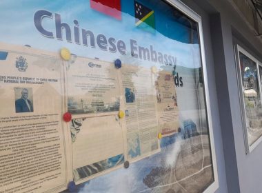 A display case of photos is seen outside the Chinese Embassy in Honiara, Solomon Islands on April 2, 2022. A Chinese state-owned company is negotiating to buy a forestry planation with a deep-water port and World War II airstrip in Solomon Islands, as concerns continue that China wants to establish a naval foothold in the South Pacific country. (AP Photo/Charley Piringi, File)