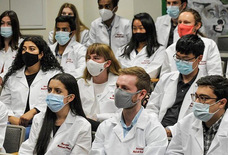 Masked Harvard Medical School students / hms.harvard.edu