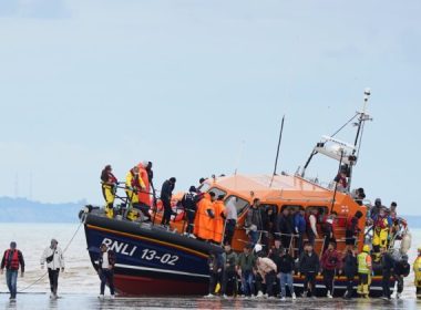 A group of illegal immigrants are brought in to Dover, England, by the Royal National Lifeboat Institute, on Aug. 25, 2022. (Gareth Fuller/PA Media)