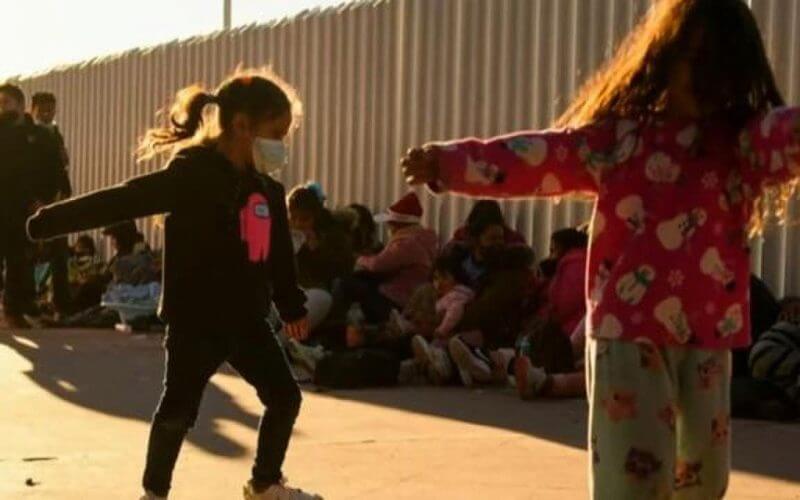 Migrant children playing at a border detention facility | CBS News report screenshot