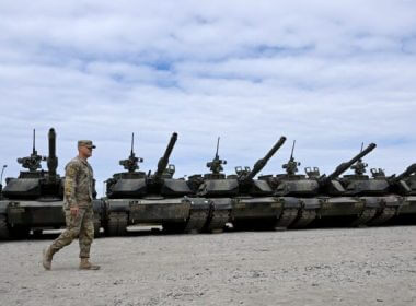 An U.S. soldier walks in front of military tanks at the United States Army military training base in Grafenwoehr, southern Germany, on July 13, 2022. (Christof Stache/AFP via Getty Images)