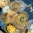 Crypto-currency coins including Bitcoin, Ethereum, Dogecoin and Cardano, GETTY