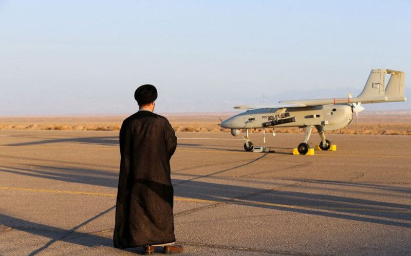 An Iranian cleric stands near a drone during a military exercise in an undisclosed location in Iran, in this handout image obtained on August 24, 2022. Iranian Army/WANA (West Asia News Agency)/Handout via REUTERS