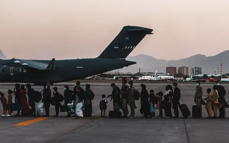 Evacuees wait to board a Boeing C-17 Globemaster III during an evacuation at Hamid Karzai International Airport in Kabul, Afghanistan, on Aug. 23, 2021. (U.S. Marine Corps photo by Sgt. Isaiah Campbell)