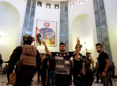Supporters of Shiite cleric Muqtada al-Sadr enter the Government Palace during a demonstration in Baghdad, Iraq, Monday, Aug. 29, 2022. AP