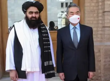 In this photo released by Xinhua News Agency, Chinese Foreign Minister Wang Yi poses for photos with Amir Khan Muttaqi, acting foreign minister of the Afghan Taliban's caretaker government, in Kabul, March 24, 2022. (Saifurahman Safi/Xinhua via AP)