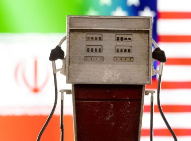 Model of petrol pump is seen in front of U.S. and Iran flag colors in this illustration taken March 25, 2022. REUTERS/Dado Ruvic/Illustration