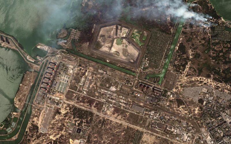 This satellite image provided by Maxar Technologies shows bush fires outside of the main power plant facilities at the Zaporizhzhia nuclear plant in Russian occupied Ukraine, Monday Aug. 29, 2022. (Satellite image ©2022 Maxar Technologies via AP)