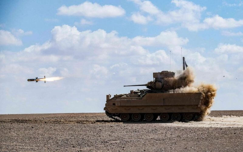 In this file photo taken on March 25, 2022, a U.S. Bradley Fighting Vehicle (BFV) fires an AGM-114 Hellfire during a heavy-weaponry military exercise in the countryside of Deir ez-Zor province in eastern Syria. Delil Souleiman/AFP via Getty Images, File