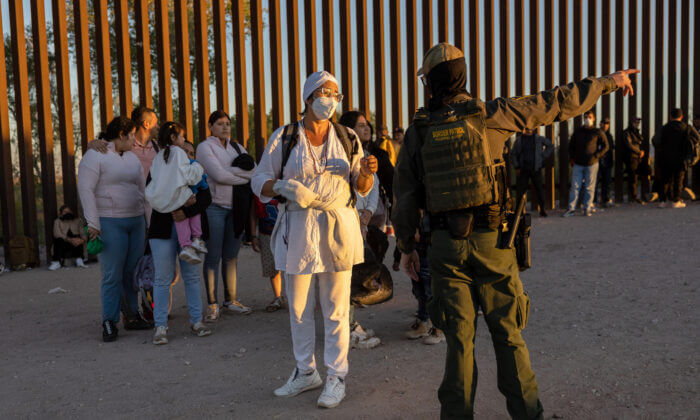 Immigrants seeking asylum in the United States wait to be processed by U.S. Border Patrol agents after crossing into Arizona from Mexico near Yuma, Ariz., on Sept. 26, 2022. (John Moore/Getty Images)