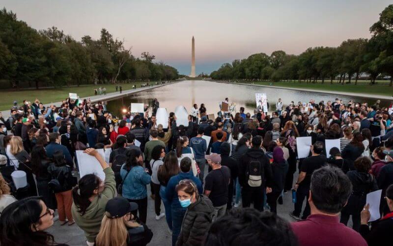 Hundreds of people attended a candlelight vigil at sunset for Mahsa Amini at the Lincoln Memorial Reflecting Pool in Washington on September 23. AP