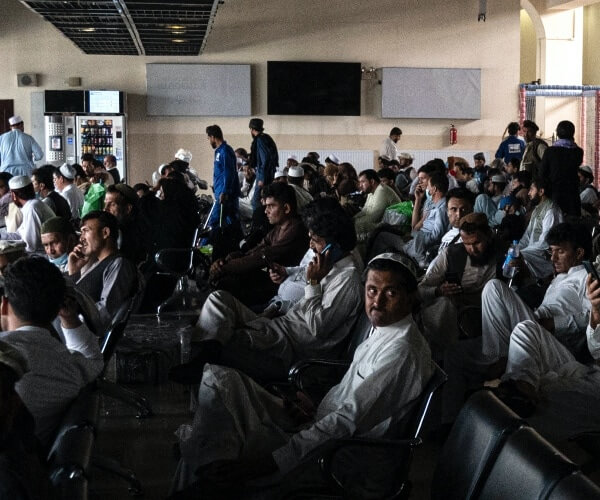 Passengers sit inside an airport terminal before boarding their flights in Kabul, Afghanistan on Aug. 1, 2021. (Wakil Kohsar/AFP via Getty Images)