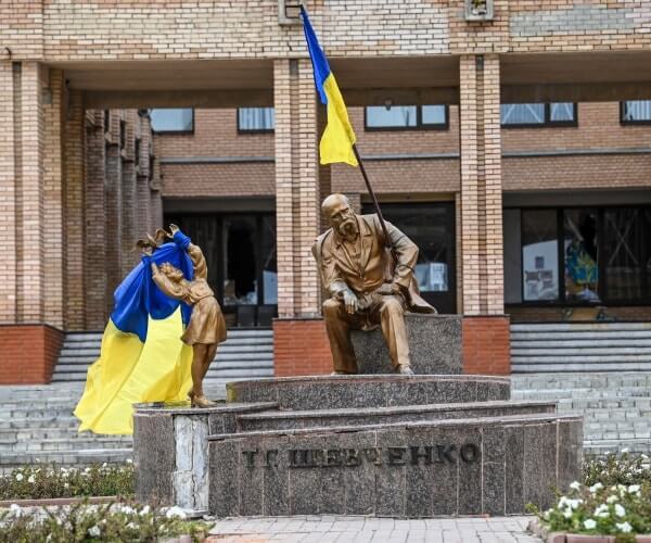 Ukrainian flags placed on statues in a square in Balakliya, Kharkiv region, amid the Russian invasion of Ukraine. Ukrainian forces said on September 10, 2022 they had entered the town of Kupiansk in eastern Ukraine, dislodging Russian troops from a key logistics hub. (Juan Barreto/AFP via Getty Images)
