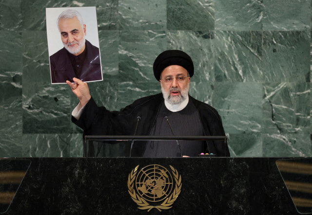 Iran's President Ebrahim Raisi holds up a picture of Quds Force Commander General Qassem Soleimani, who was killed in a U.S. attack, as he addresses the 77th Session of the United Nations General Assembly at U.N. Headquarters in New York, Sept. 21, 2022. (Photo: REUTERS/Brendan McDermid)