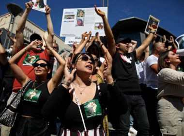 Hundreds of people gather Sunday in front of the Sherman Oaks Galleria in memory of Mahsa Amini, a 22-year-old woman who died in police custody. (Gary Coronado / Los Angeles Times)