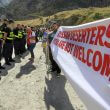 Georgian police form a line in front of activists holding an anti-Russian banner during an action organized by political party Droa near the border crossing at Verkhny Lars between Georgia and Russia in Georgia, Wednesday, Sept. 28, 2022. AP