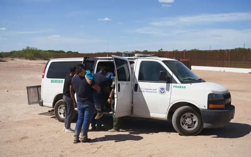 Migrants are transported after waiting in high heat to be processed by U.S. Border Patrol after illegally crossing into Eagle Pass, Texas. Anadolu Agency via Getty Images