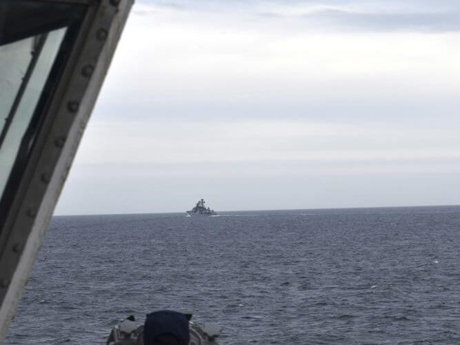 In this photo provided by the U.S. Coast Guard, a Coast Guard Cutter Kimball crew-member observes a foreign vessel in the Bering Sea, Monday, Sept. 19, 2022. (U.S. Coast Guard District 17 via AP)