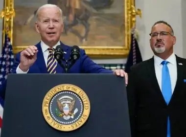 President Joe Biden speaks about student loan debt forgiveness in the Roosevelt Room of the White House, Wednesday, Aug. 24, 2022, in Washington. Education Secretary Miguel Cardona listens at right. AP Photo/Evan Vucci