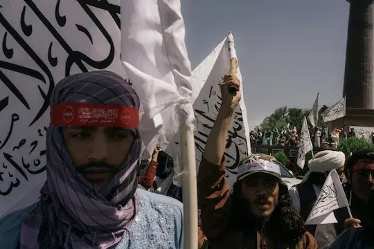 Taliban militants and civilians celebrate the first anniversary of the U.S. withdrawal from Afghanistan, in Kabul's Massoud Square on Aug. 31. (Lorenzo Tugnoli for The Washington Post)