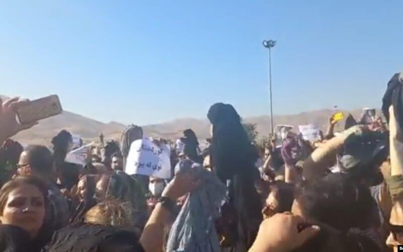 A screenshot of video circulating on social media purports to show women in Saqez, Iran, removing their headscarves in protest against the death of 22-year-old Mahsa Amini, who died after being detained by morality police enforcing strict hijab rules. Social Media