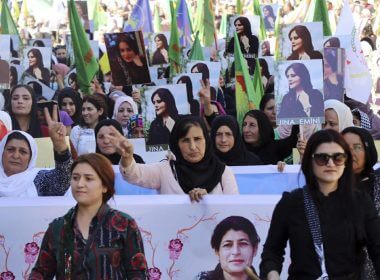 In this photo provided by Kurdish-run Hawar News Agency, Kurdish women hold portraits of Iranian Mahsa Amini, during a protest condemning her death in Iran, in the city of Qamishli, northern Syria, Monday, Sept. 26, 2022. AP