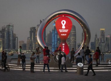 People gather around the official countdown clock showing remaining time until the kick-off of the World Cup 2022, in Doha, Qatar, November 25, 2021. (AP/Darko Bandic)