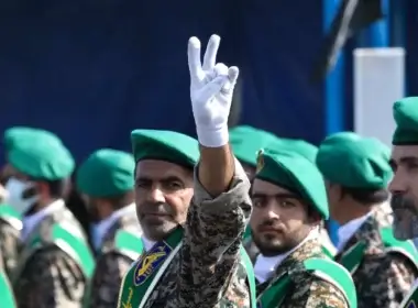 A member of Iran's Basij paramilitary force flashes a victory sign during a military parade just outside Tehran, Iran, Sept. 22, 2022. AP