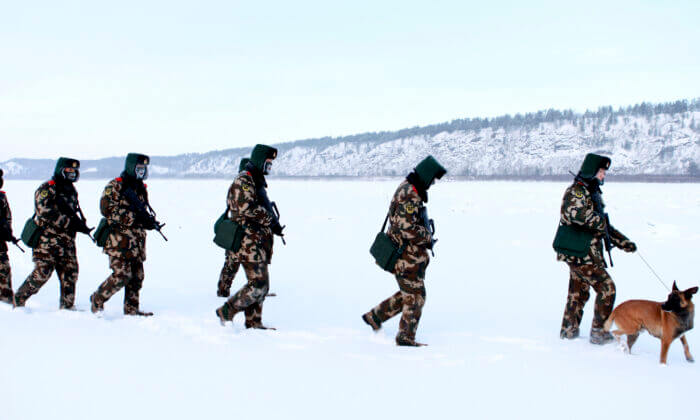 Chinese paramilitary police border guards train in the snow at Mohe County in China's northeast Heilongjiang province, on the border with Russia, on Dec. 12, 2016. Mohe is the northernmost point in China, with a sub arctic climate where border guards operate in temperatures as low as -32 degrees F. (STR/AFP via Getty Images)