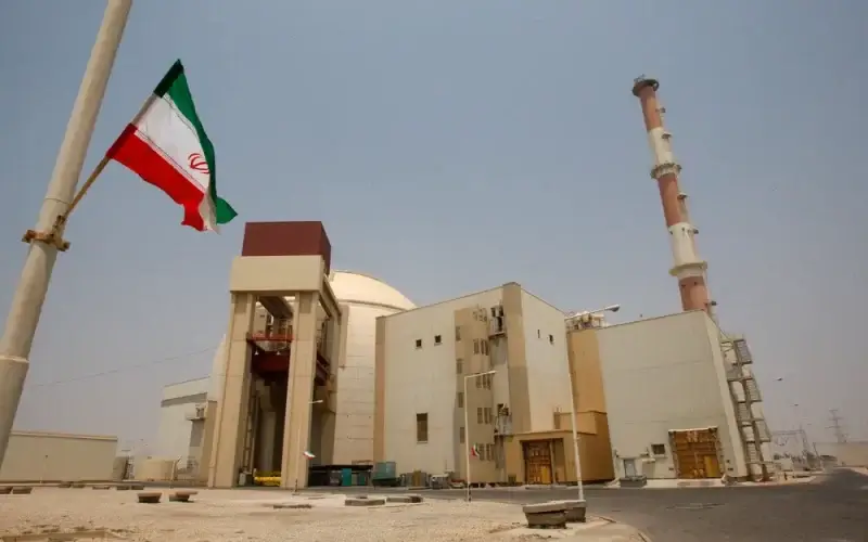 An Iranian flag flutters in front of the reactor building of the Bushehr nuclear power plant, just outside the southern city of Bushehr, Iran. AP