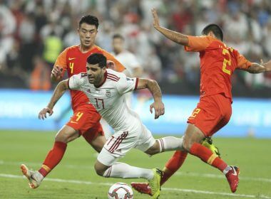 Iran forward Mehdi Taremi falls between China's Shi Ke , left, and Liu Yiming during the AFC Asian Cup quarterfinal soccer match between Iran and China at Mohammed Bin Zayed Stadium in Abu Dhabi, United Arab Emirates, Thursday, Jan. 24, 2019. (AP Photo/Kamran Jebreili, File)