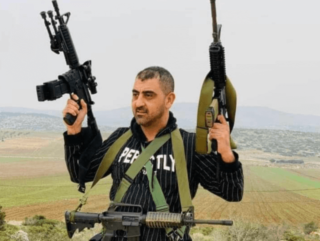 Palestinian doctor, Abdullah Abu Tin, a member of the al-Aqsa Martyrs Brigades, is seen holding several assault rifles in an undated photo circulated online after his death during a clash with IDF soldiers, Oct. 14, 2022. (Photo: Twitter)