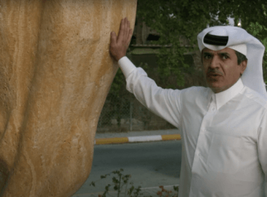 Qatari Sheikh Hamad Al Suwaidi with a three-meter high stone replica of the World Cup trophy he installed outside his home in Doha. (Photo: Screenshot)