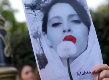 Demonstrators hold placards outside the Iranian Embassy in London, Sunday, Sept. 25, 2022. They were protesting against the death of Iranian Mahsa Amini, a 22-year-old woman who died in Iran while in police custody, who was arrested by Iran’s morality police for allegedly violating its strictly-enforced dress code. (AP Photo/Alastair Grant)