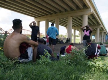 Migrants wait to be processed by the Border Patrol after illegally crossing the Rio Grande river from Mexico into the U.S. at Eagle Pass, Texas, Friday, Aug. 26, 2022. Eric Gay