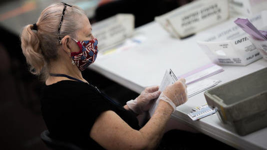 A Nevada poll worker during the 2020 primary election. Konnech and its CEO, Eugene Yu, are accused of mismanaging data on poll workers. The software company has contracts with multiple U.S. counties that use its services to schedule and manage election workers. Critically, none of the data in question relates to votes, voters, or election outcomes. Trevor Bexon (Shutterstock)