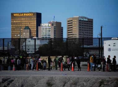 Asylum-seeking migrants wait in line to be processed by U.S. Border Patrol after crossing the border to El Paso, Texas, U.S., as seen from Ciudad Juarez, Mexico, October 3, 2022. REUTERS/Paul Ratje