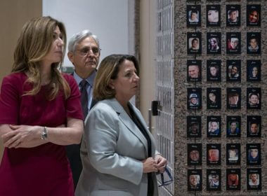 Attorney General Merrick Garland, center, Deputy Attorney General Lisa Monaco, right, and Drug Enforcement Administration Administrator Anne Milgram walk through the exhibition of "The Faces of Fentanyl" wall at DEA headquarters before a press event to announce the results of an enforcement surge to reduce the fentanyl supply across the United States, at DEA headquarters, Arlington, Va., Tuesday, Sept. 27, 2022. AP