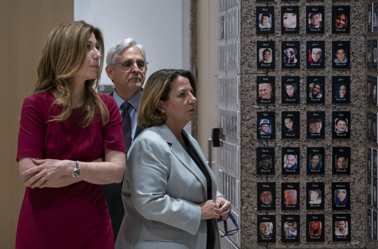 Attorney General Merrick Garland, center, Deputy Attorney General Lisa Monaco, right, and Drug Enforcement Administration Administrator Anne Milgram walk through the exhibition of "The Faces of Fentanyl" wall at DEA headquarters before a press event to announce the results of an enforcement surge to reduce the fentanyl supply across the United States, at DEA headquarters, Arlington, Va., Tuesday, Sept. 27, 2022. AP