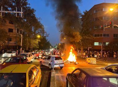 A police motorcycle burns during a protest over the death of Mahsa Amini, a woman who died after being arrested by the Islamic republic's "morality police", in Tehran, Iran September 19, 2022. WANA (West Asia News Agency) via REUTERS