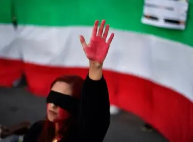 A woman raises her hand with red paint during a demonstration in support of Iranian women on Oct. 4, 2022, in Barcelona following the death of Kurdish Iranian woman Mahsa Amini in Iran. AFP