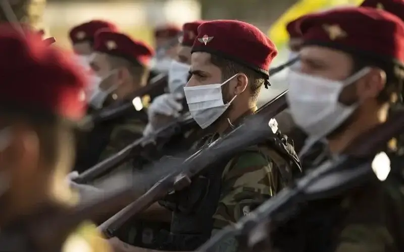 Members of the Hashed al-Shaabi (Popular Mobilisation) paramilitary force take part in a military parade in the southern Iraqi city of Basra on June 14, 2020. AFP