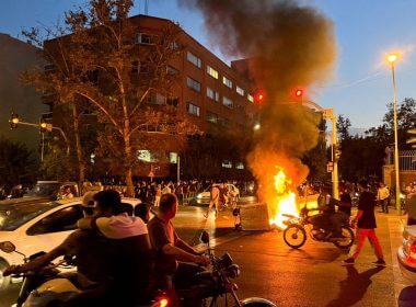 A police motorcycle burns during a protest over the death of Mahsa Amini, a woman who died after being arrested by the Islamic republic's "morality police", in Tehran, Iran September 19, 2022. WANA (West Asia News Agency) via REUTERS